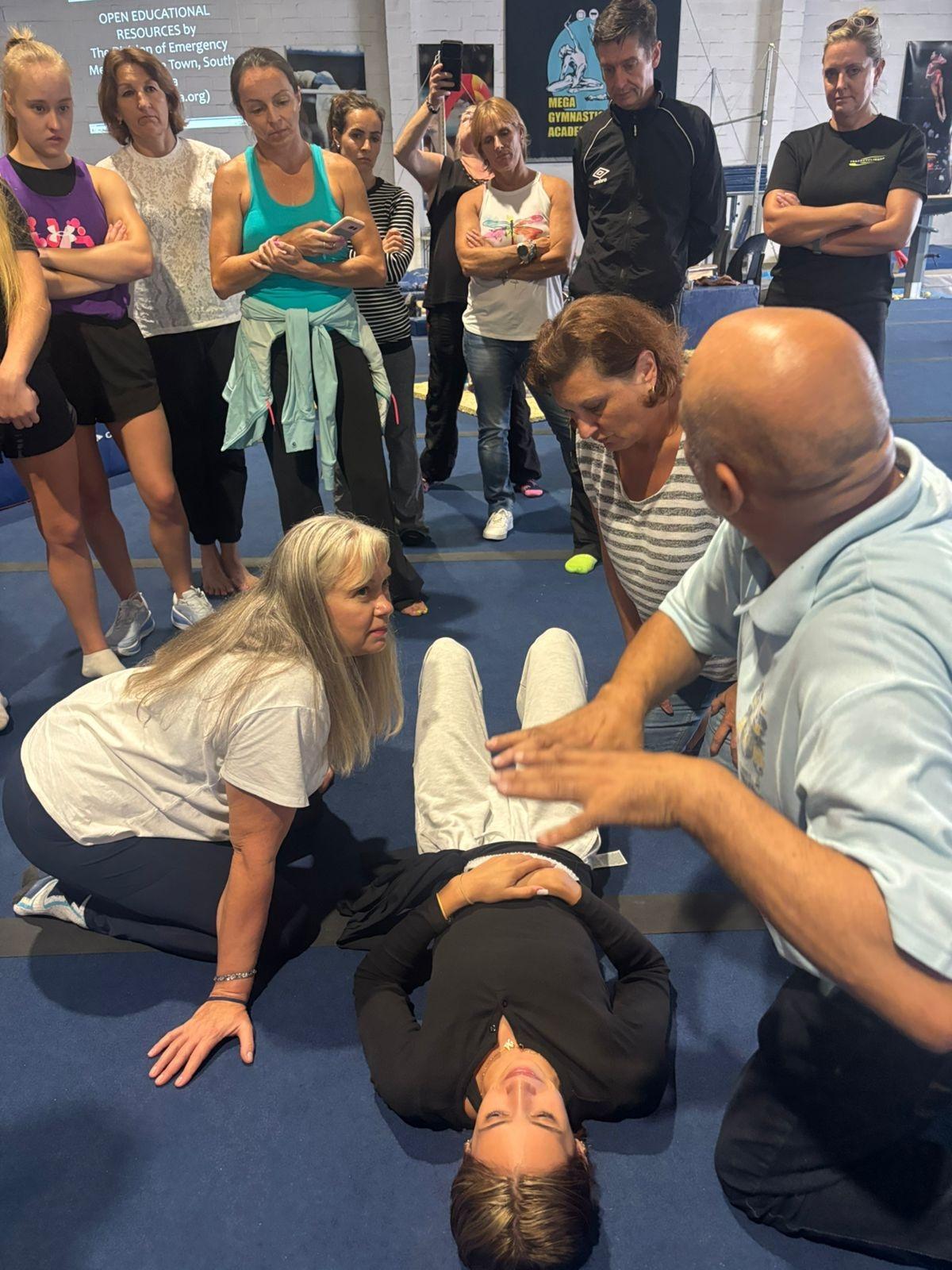 Learners practising first aid response techniques